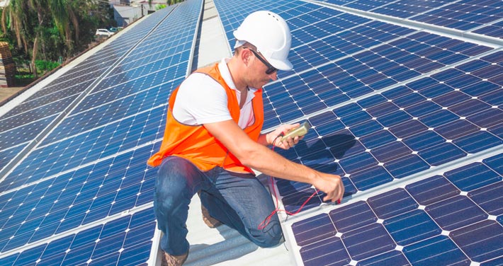 worker checking solar panel