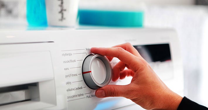 hand on dial of energy star washing machine