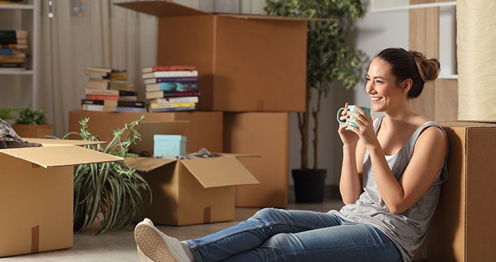 woman sitting with boxes to unpack