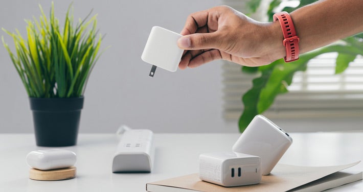 person removing plug from power strip