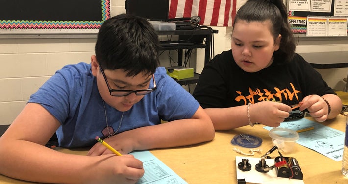 Students work together to create an open and closed circuit