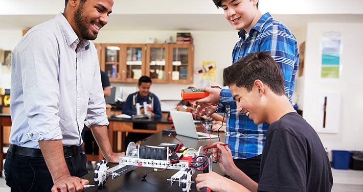 teacher and students collaborate in school classroom