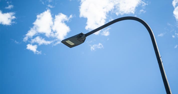 detailed view of street light against blue sky