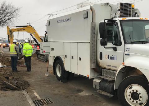 workers next to Unitil truck supervising ground excavation