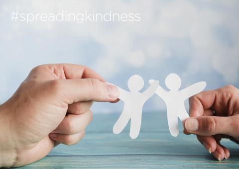 hands holding paper cutouts shaped like people