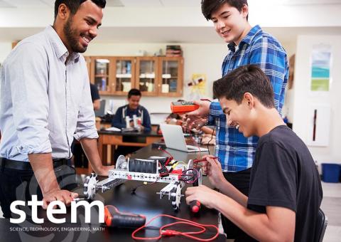 teacher and students collaborate in school classroom