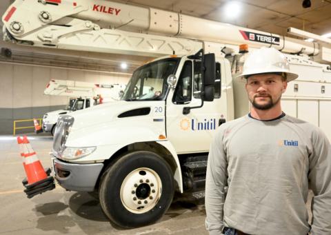 Lineworker Poses in Front of Company Truck